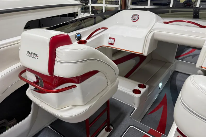 Slide: The Image of Interior of 2004 Sleekcraft Enforcer 30 boat with red accents and modern amenities. - 24