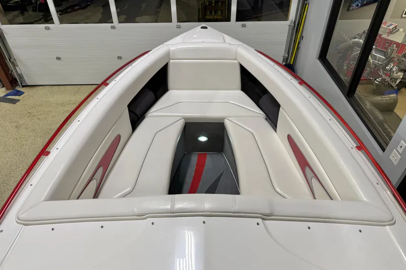 Slide: The Image of 2004 Sleekcraft Enforcer 30 boat interior with white and red cushioned seating. - 26