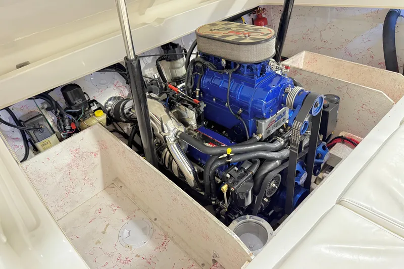 Slide: The Image of Engine compartment of a 2004 Sleekcraft Enforcer 30 boat, showcasing a powerful blue engine. - 17