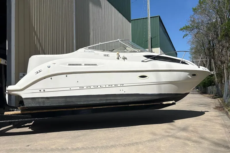 Slide: The Image of 2001 Bayliner 2655 Ciera boat on trailer outside a warehouse. - 1