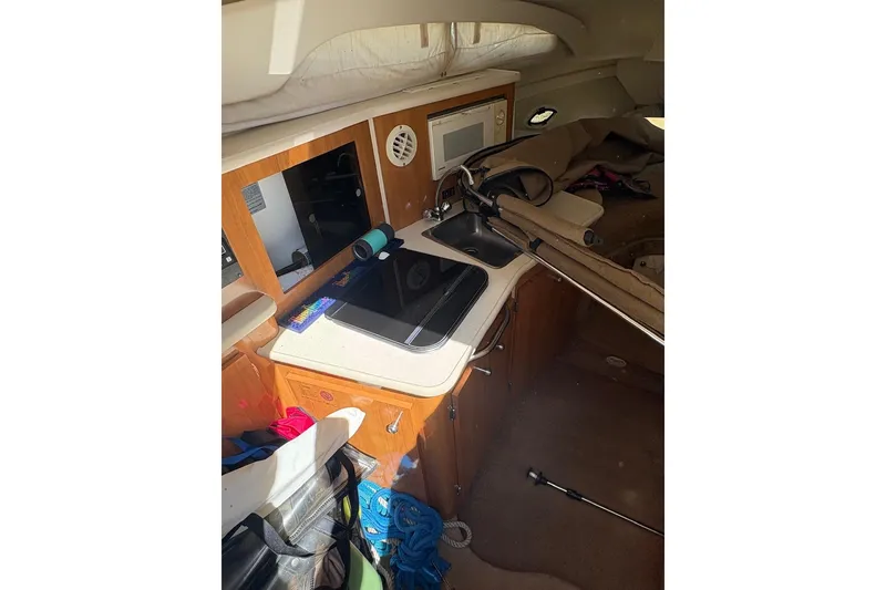 Slide: The Image of Interior of 2001 Bayliner 2655 Ciera boat with kitchenette and storage space. - 10