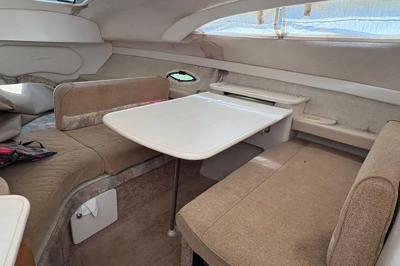 Slide: The Image of 2001 Bayliner 2655 Ciera cabin interior with dining table and seating area. - 13