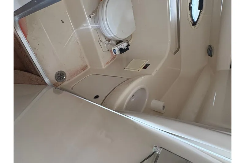 Slide: The Image of 2001 Bayliner 2655 Ciera boat bathroom with toilet and porthole window. - 14