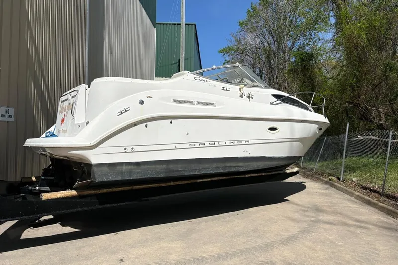 Slide: The Image of 2001 Bayliner 2655 Ciera boat on trailer, parked outdoors near a building. - 3