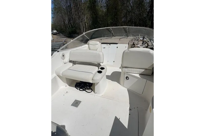 Slide: The Image of 2001 Bayliner 2655 Ciera boat interior with white seating and steering console. - 4