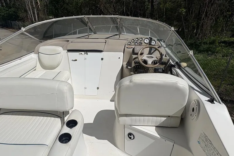 Slide: The Image of 2001 Bayliner 2655 Ciera boat cockpit with white seating and control panel. - 5