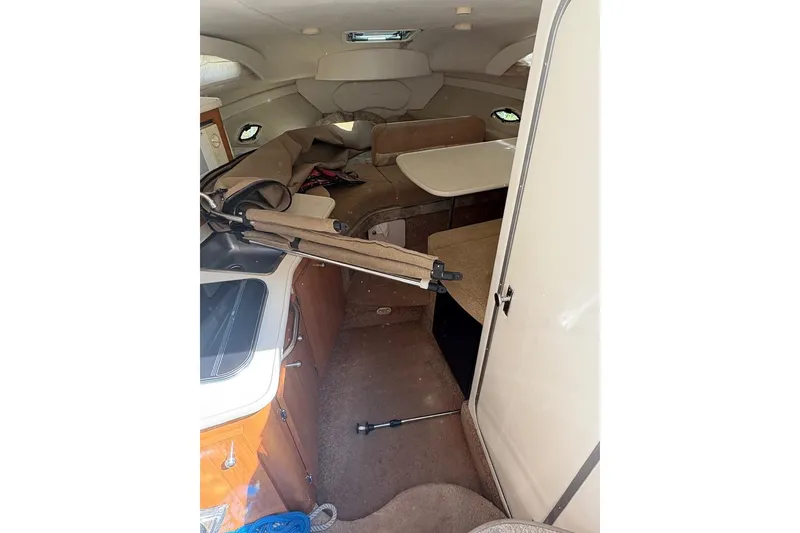 Slide: The Image of Interior of 2001 Bayliner 2655 Ciera boat, featuring compact cabin and kitchenette. - 9