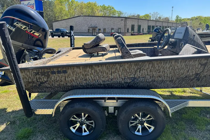 Slide: The Image of 2026 Xpress H20 Bass boat on trailer with Yamaha engine, parked outdoors. - 11