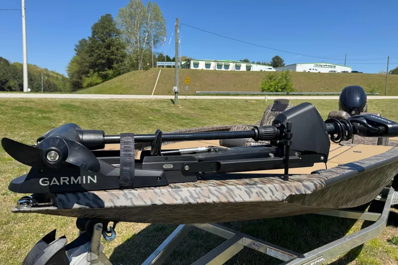 Slide: The Image of 2026 Xpress H20 Bass boat with Garmin trolling motor on a sunny day. - 3