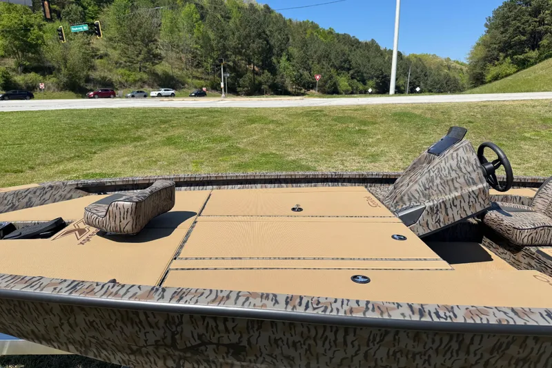 Slide: The Image of 2026 Xpress H20 Bass boat with camouflage design on grassy area. - 5