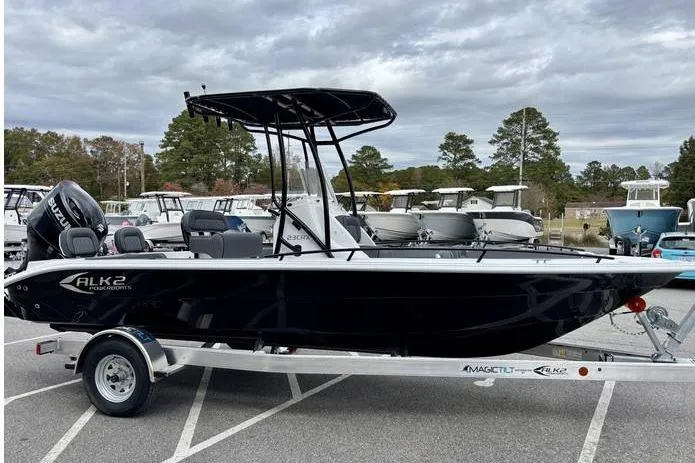 Slide: The Image of 2026 ALK2 23CRX boat on trailer, black hull, parked outdoors. - 5