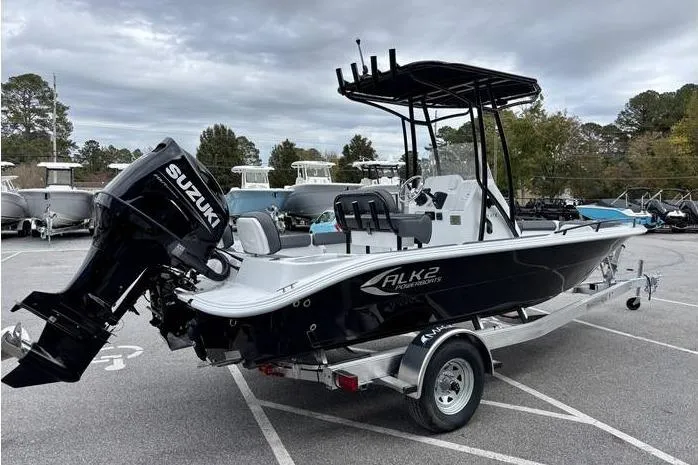 Slide: The Image of 2026 ALK2 23CRX boat with Suzuki outboard motor on a trailer in a parking lot. - 6