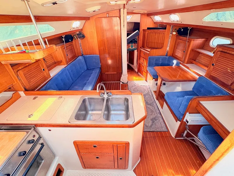 Slide: The Image of Interior of a 2001 Catalina 36 Mark II yacht with wood finish and blue upholstery. - 13