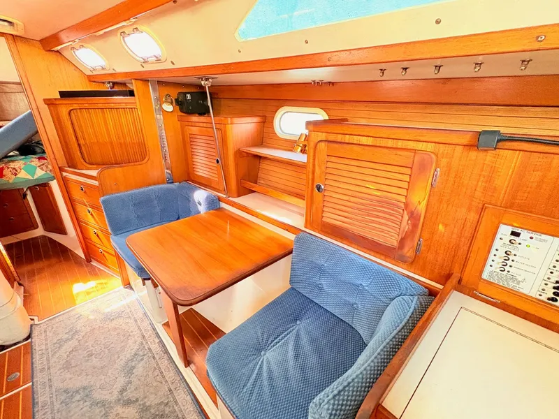 Slide: The Image of Interior of a 2001 Catalina 36 Mark II yacht with wooden furnishings and blue upholstery. - 21