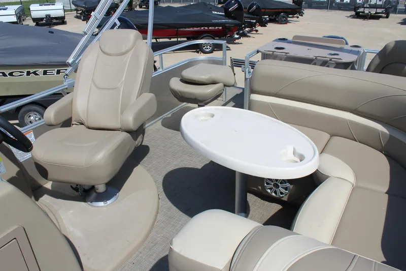 Slide: The Image of 2020 SunChaser Geneva Fish 20 4.0 pontoon boat interior with beige seating and table. - 15