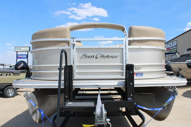 Slide: The Image of 2020 SunChaser Geneva Fish 20 4.0 pontoon boat on trailer under clear blue sky. - 3