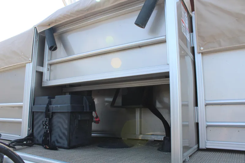 Slide: The Image of 2020 SunChaser Geneva Fish 20 4.0 pontoon boat storage compartment with equipment. - 31