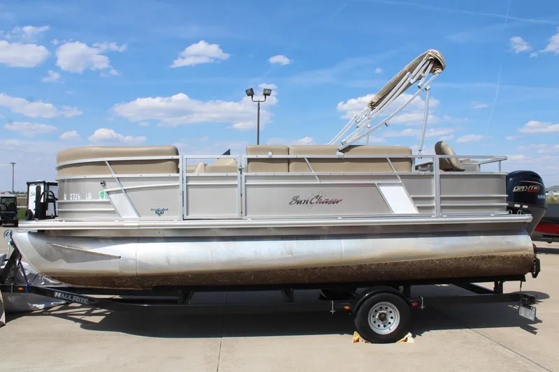 Slide: The Image of 2020 SunChaser Geneva Fish 20 4.0 pontoon boat on trailer under blue sky. - 5