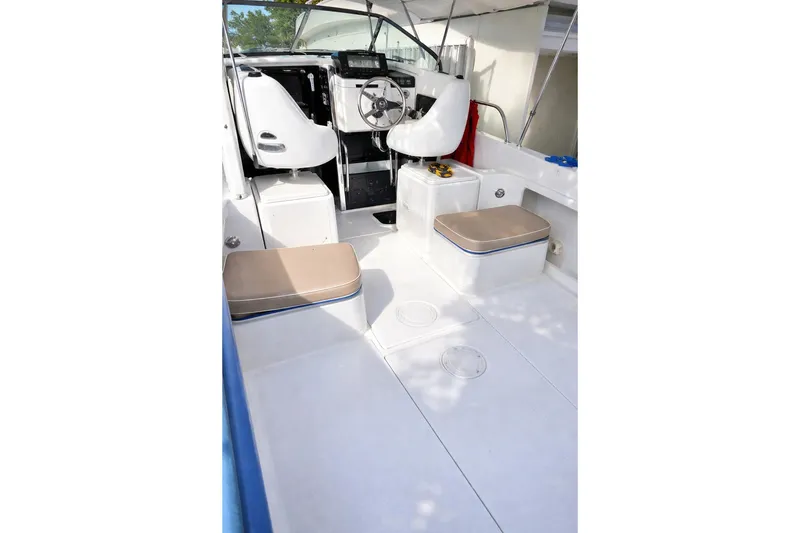 Slide: The Image of 1989 Grady-White Offshore 242 boat interior with seating and steering wheel. - 10