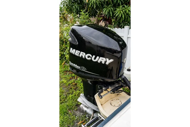 Slide: The Image of 1989 Grady-White Offshore 242 with Mercury OptiMax outboard motor in a garden setting. - 13