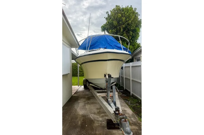 Slide: The Image of 1989 Grady-White Offshore 242 boat on trailer, covered with blue tarp. - 15