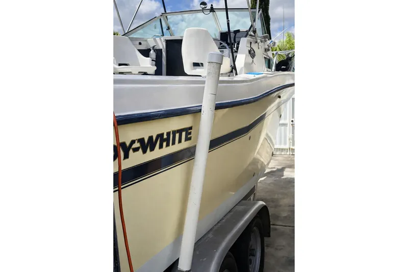 Slide: The Image of 1989 Grady-White Offshore 242 boat on trailer, side view with visible seating. - 2