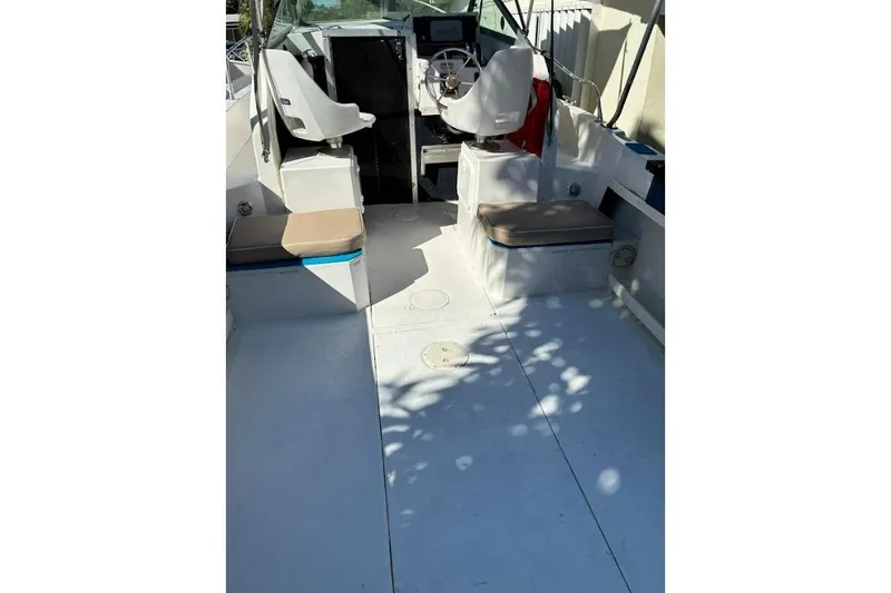 Slide: The Image of 1989 Grady-White Offshore 242 boat interior with seating and steering wheel. - 3