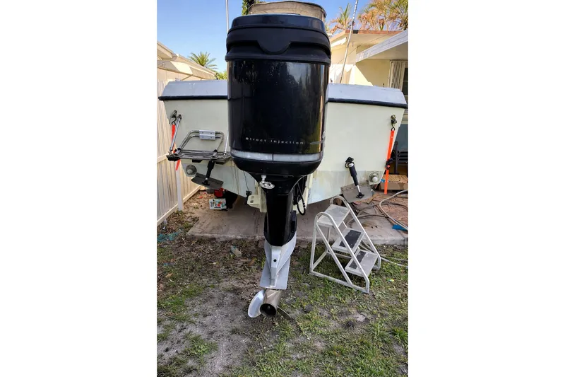 Slide: The Image of 1989 Grady-White Offshore 242 boat with outboard motor, parked on grass. - 7