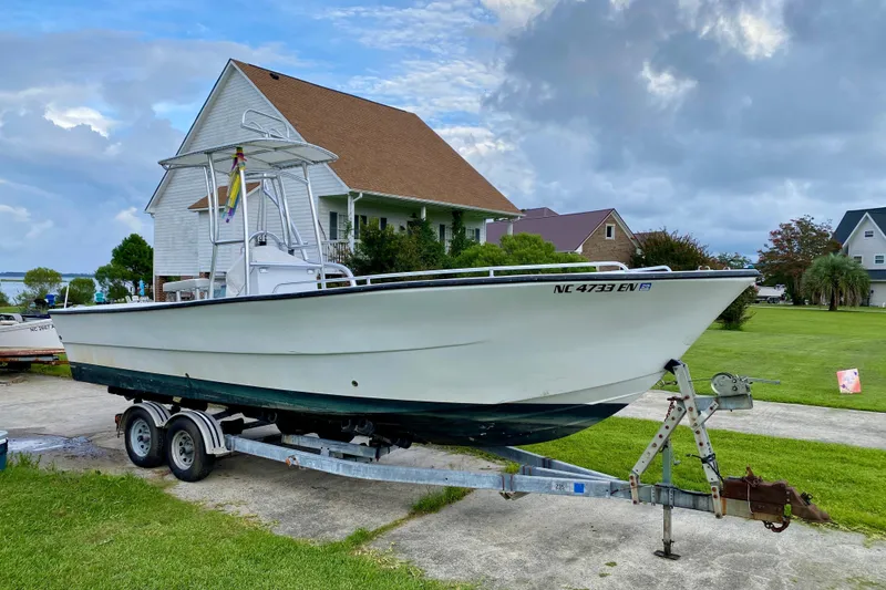 Slide: The Image of 1996 Premium 28 Parasail boat on trailer, parked in residential driveway. - 34