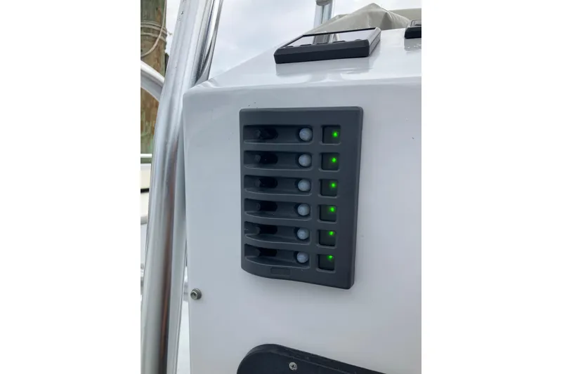 Slide: The Image of Control panel on a 1996 Premium 28 Parasail boat with illuminated switches. - 17