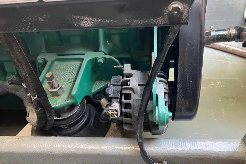 Slide: The Image of Engine component of a 1996 Premium 28 Parasail boat, featuring a visible alternator. - 20