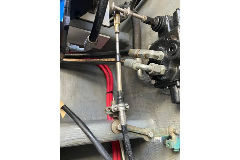 Slide: The Image of Close-up of mechanical components and cables in a 1996 Premium 28 Parasail boat. - 25