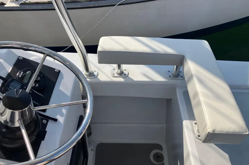 Slide: The Image of Steering wheel and seating area of a 1996 Premium 28 Parasail boat. - 28