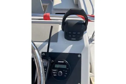 Slide: The Image of Control panel of a 1996 Premium 28 Parasail boat with radio and steering wheel. - 29