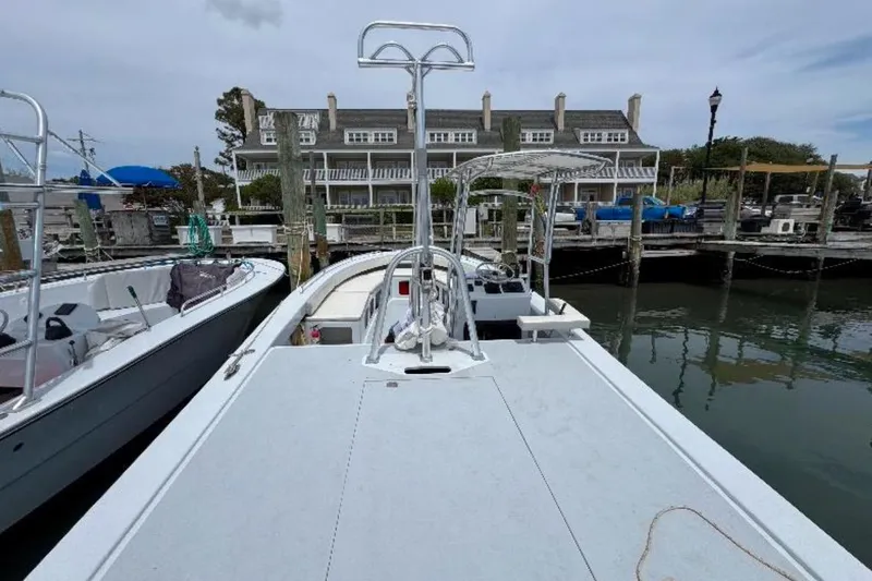 Slide: The Image of 1996 Premium 28 Parasail boat docked at marina with waterfront buildings. - 6