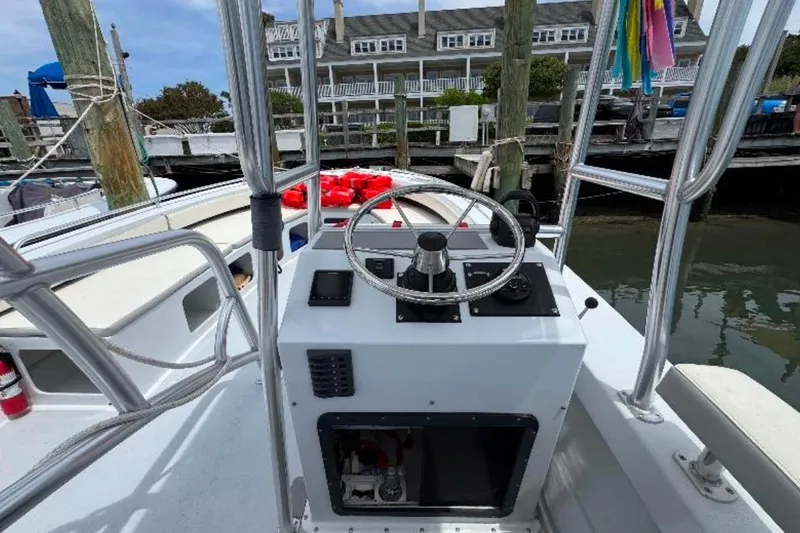 Slide: The Image of Control console of a 1996 Premium 28 Parasail boat docked at a marina. - 7