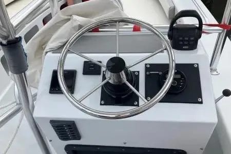 Slide: The Image of Steering console of a 1996 Premium 28 Parasail boat with navigation controls. - 8