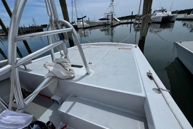 Slide: The Image of 1996 Premium 28 Parasail boat docked at marina, featuring sturdy metal railings. - 9