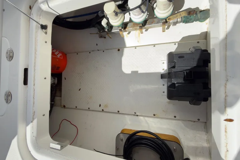 Slide: The Image of Storage compartment of a 2007 Everglades 350 Center Console boat, showing equipment and wiring. - 11