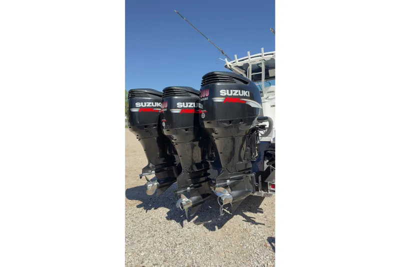 Slide: The Image of Triple Suzuki outboard motors on a 2007 Everglades 350 Center Console boat. - 14
