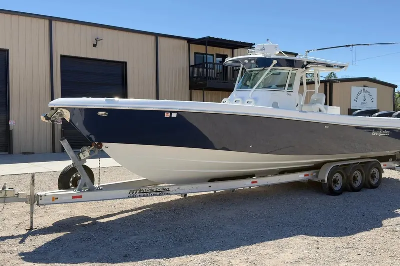 Slide: The Image of 2007 Everglades 350 Center Console boat on trailer, parked outside a marine facility. - 2