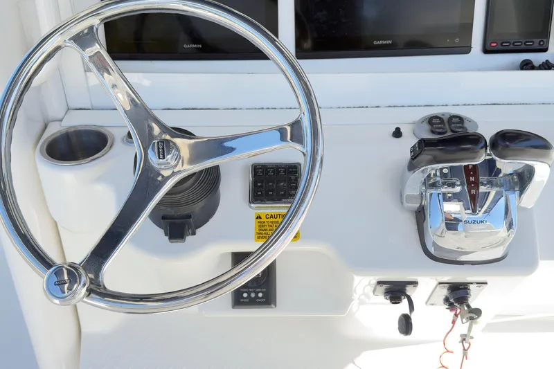Slide: The Image of Steering wheel and controls of a 2007 Everglades 350 Center Console boat. - 4