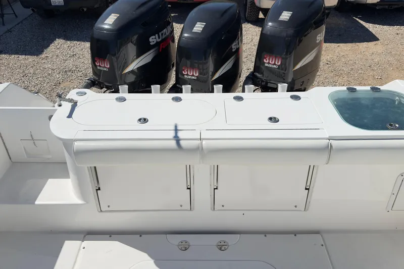 Slide: The Image of 2007 Everglades 350 Center Console boat with Suzuki 300 engines, featuring a spacious deck layout. - 7