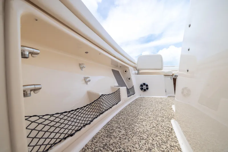 Slide: The Image of 2021 Grady-White Canyon 376 boat interior with storage nets and speaker system. - 13