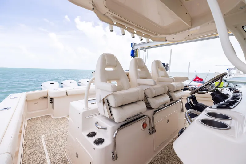Slide: The Image of 2021 Grady-White Canyon 376 boat interior with helm and seating, ocean view. - 15