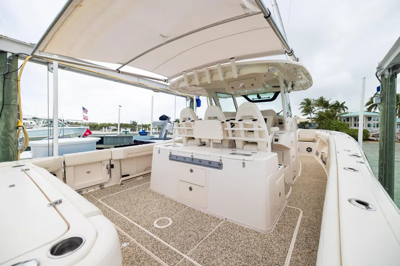Slide: The Image of 2021 Grady-White Canyon 376 boat interior with seating and storage, docked at marina. - 22
