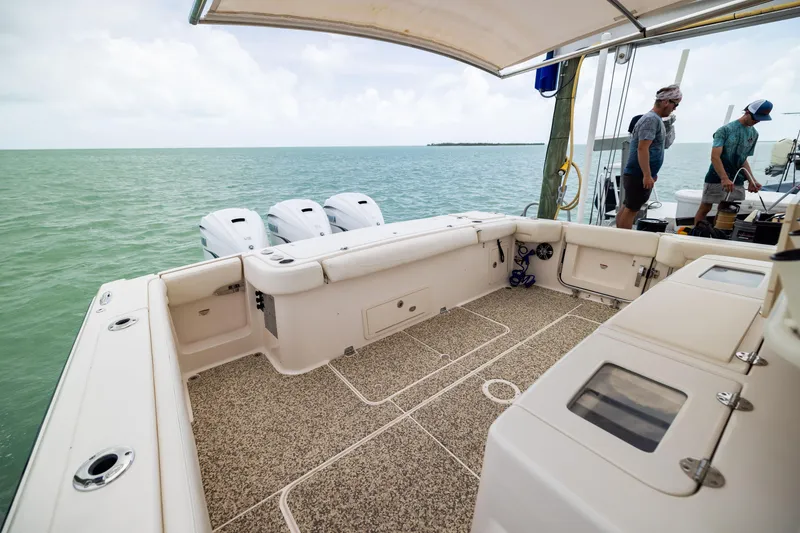 Slide: The Image of 2021 Grady-White Canyon 376 boat interior with ocean view and triple outboard engines. - 25