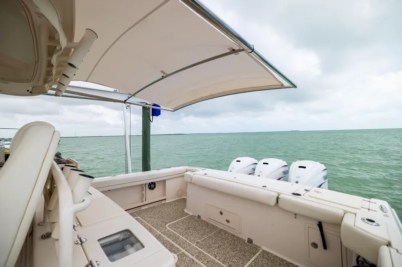 Slide: The Image of 2021 Grady-White Canyon 376 boat with triple engines on calm sea. - 27