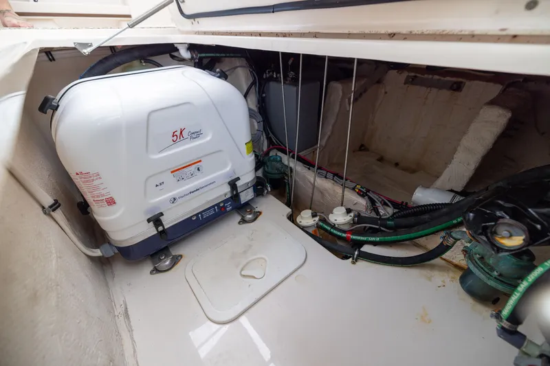 Slide: The Image of 2021 Grady-White Canyon 376 boat engine compartment with generator and wiring. - 32