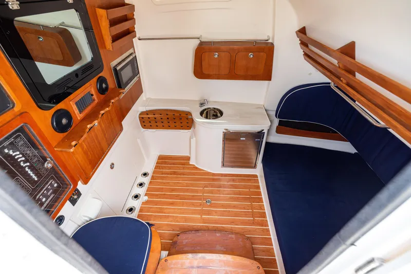 Slide: The Image of 2021 Grady-White Canyon 376 cabin interior with wood accents and modern amenities. - 34
